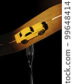 a metaphorical composition about a fork in the road, the fork holds the road along which the car is driving, consecrating the road with headlights 99648414