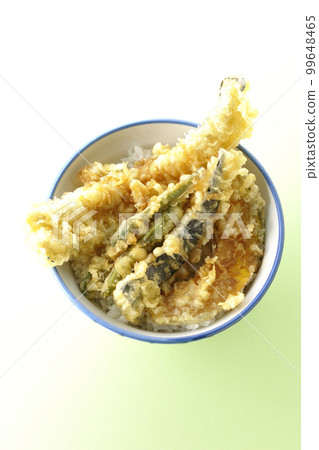 A bird's-eye view of a bowl of rice topped with conger eel, eggplant, pumpkin, and green bean tempura 99648465