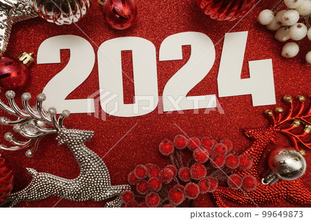 2024 Happy New Year and Christmas decoration on red glitter background 2024 Happy New Year and Christmas decoration on red glitter background 99649873