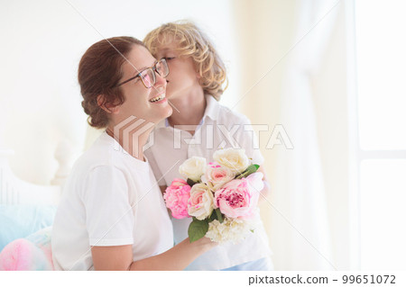 Child giving mom present. Mother day gift. 99651072