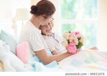 Child giving mom present. Mother day gift. 99651078