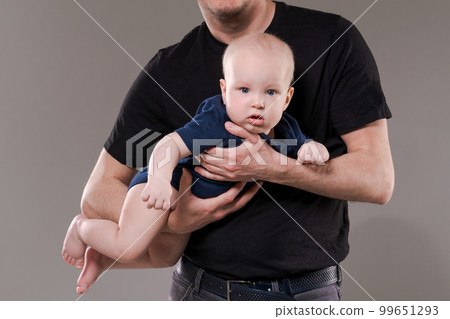 Happy dad with his little son in studio on background. Caring Caucasian dad Happy dad with his little son in studio on background. Caring Caucasian dad 99651293