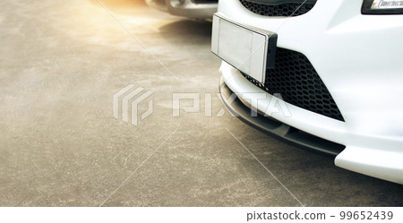 Close up view of front car bumper on parking lot 99652439