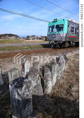 Stone Buddha and train of Jomo Electric Railway Stone Buddha and train of Jomo Electric Railway 99653142