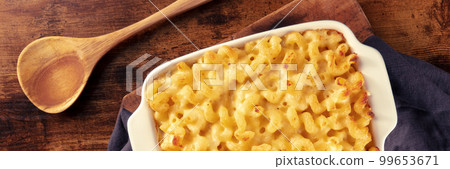 Macaroni and cheese pasta in a casserole panorama, overhead flat lay shot 99653671