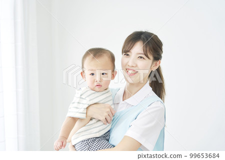 Child nurse holding a baby Child nurse holding a baby 99653684
