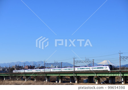 E353 series limited express train crossing the Tamagawa Bridge in sunny winter E353 series limited express train crossing the Tamagawa Bridge in sunny winter 99654398