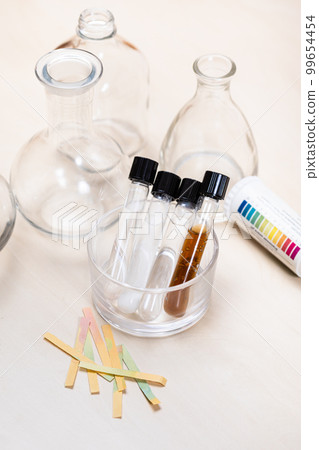 test tubes with liquids, flask and indicator paper 99654454
