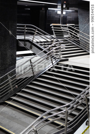 stairs with steel railings in underground passage 99654458