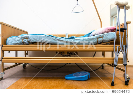 adjustable hospital bed and crutches at home 99654473
