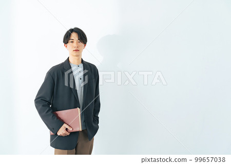 Portrait of a young man with a book 99657038