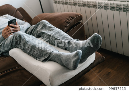 man leaning his legs on a leg man leans his legs on a leg elevation pillow pillow man leaning his legs on a leg man leans his legs on a leg elevation pillow pillow 99657213