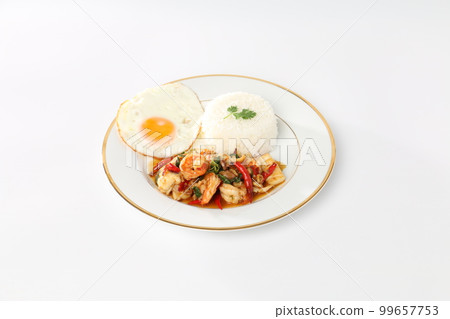 Rice topped with stir-fried seafood and holy basil, fried egg, white plate. Rice topped with stir-fried seafood and holy basil, fried egg, white plate. 99657753