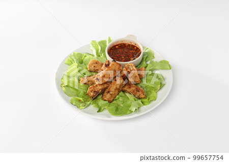 fried Vietnamese pork sausage or Thai northern pork sausage in white dish with green salad, Thai food. fried Vietnamese pork sausage or Thai northern pork sausage in white dish with green salad, Thai food. 99657754