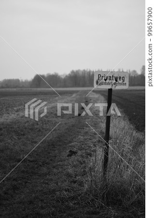 Vertical greyscale shot of a sign showing a private way on a field in Meerbusch, Germany Vertical greyscale shot of a sign showing a private way on a field in Meerbusch, Germany 99657900
