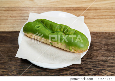 Matcha eclair on a white plate Matcha eclair on a white plate 99658752