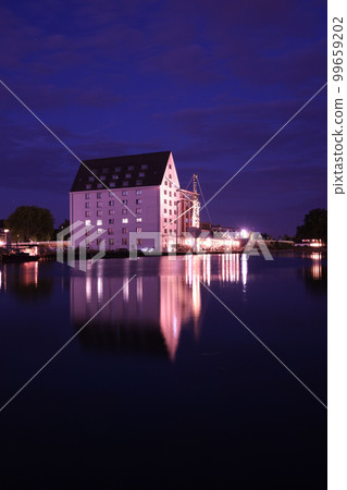 Old storehouse with white facade at night at the old harbour in Muenster in Westphalia, North Rhine-Westphalia Germany Old storehouse with white facade at night at the old harbour in Muenster in Westphalia, North Rhine-Westphalia Germany 99659202