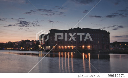 Old brick building illuminated at sunset in the harbor of Munster, Germany 99659271