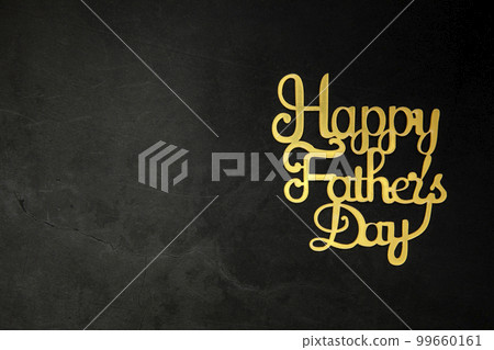 Happy Fathers Day concept. Gold shiny Letters with text Happy Father's Day on concrete dark black background Flat lay, top view, copy space 99660161