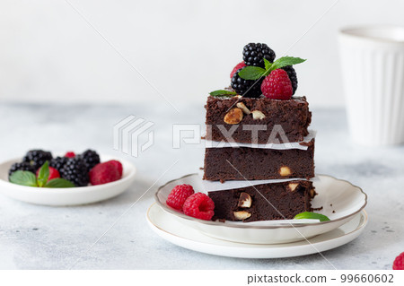 stack of chocolate brownies with raspberries and blackberries stack of chocolate brownies with raspberries and blackberries 99660602