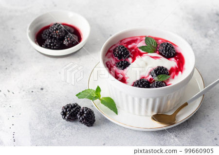 natural yogurt with homemade blackberry compote in a white bowl natural yogurt with homemade blackberry compote in a white bowl 99660905