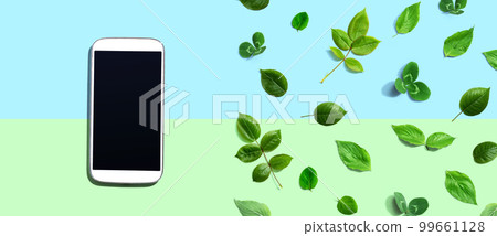 White smartphone with green leaves White smartphone with green leaves 99661128