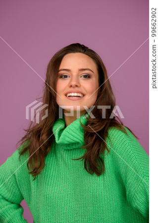 Young woman posing in sweater during studio shooting. 99662902