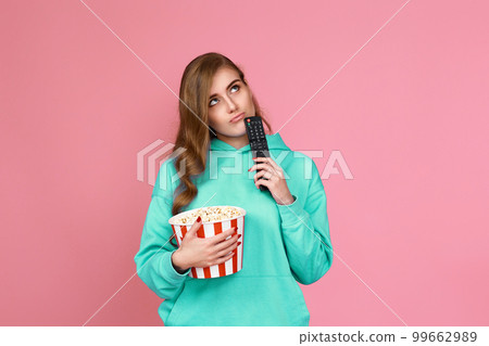 woman in sweatshirt, 3d glasses with remote control 99662989
