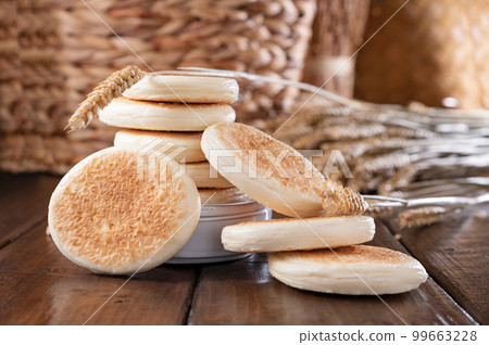 tigelle or crescentine homemade,an Italian food typical of the area of Modena.Thin round breads from tigelle or crescentine homemade,an Italian food typical of the area of Modena.Thin round breads from 99663228