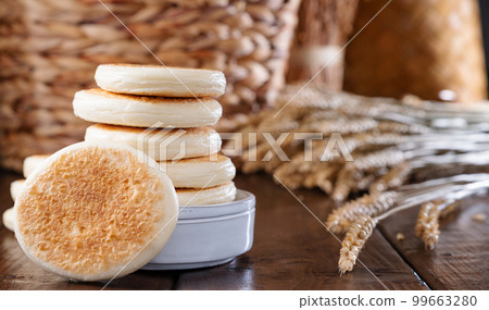 tigelle or crescentine homemade,an Italian food typical of the area of Modena.Thin round breads from tigelle or crescentine homemade,an Italian food typical of the area of Modena.Thin round breads from 99663280