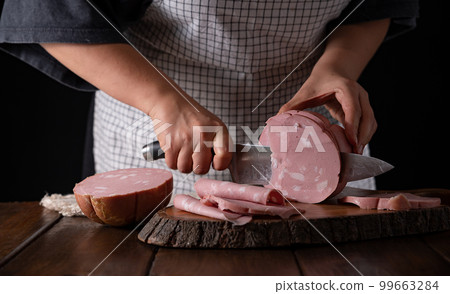 Mortadella. Traditional pork sausage with pistachios or black pepper. Italian delicacy from Bologna. Mortadella. Traditional pork sausage with pistachios or black pepper. Italian delicacy from Bologna. 99663284
