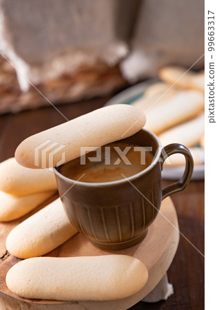 Cookies cat's tongue. Traditional Indonesian and Italian biscuit pastries. Dessert and espresso 99663317