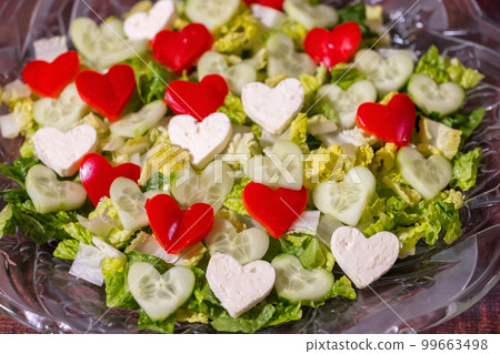 Fresh Salad on a plate with Red, Green and White Heart Shapes. 99663498