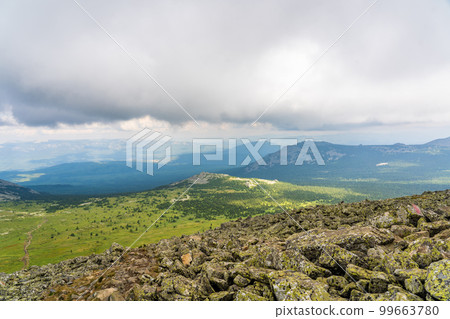 Forests and mountains of the Southern Urals near the village of Tyulyuk in Russia. Drone view. Forests and mountains of the Southern Urals near the village of Tyulyuk in Russia. Drone view. 99663780