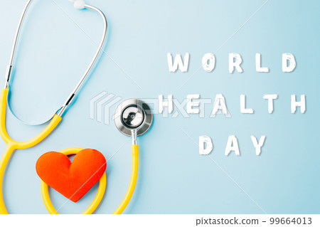 World Health Day. Yellow doctor stethoscope and world globe with Red heart shape isolated on blue background with copy space, Save world day, Healthcare life Insurance, Health care and medical concept 99664013