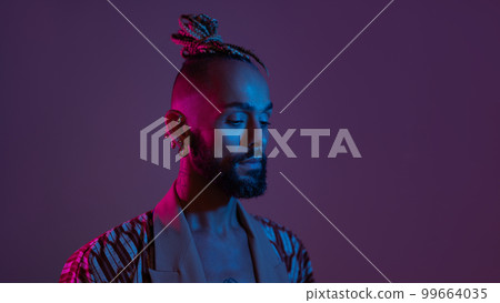 Neon light studio close-up portrait handsome black gay man looking camera. Neon light studio close-up portrait handsome black gay man looking camera. 99664035