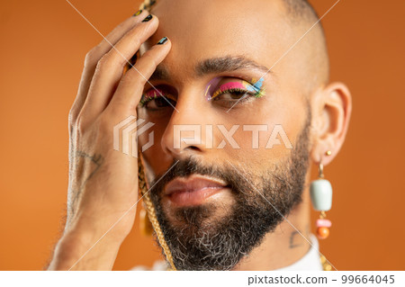 Black latin gay man isolated on pink background Black latin gay man isolated on pink background 99664045