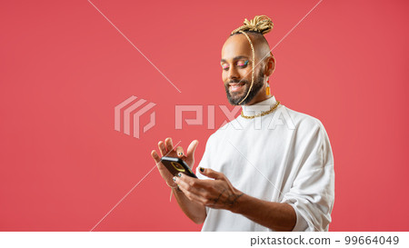 African-american gay use smartphone isolated on pink 99664049