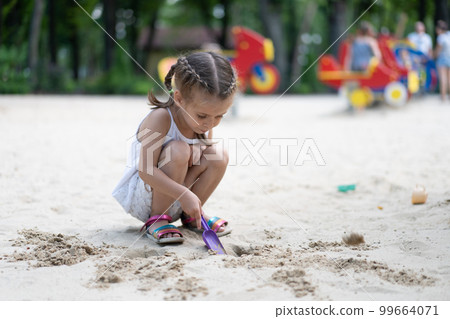 Little Girl Playing Sandbox 99664071