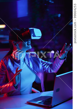 smiling business woman designing metaverse in modern office 99664253