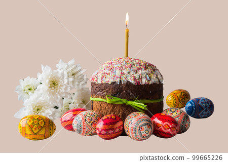 Easter cake kulich lighted candle and painted eggs with spring flowers on isolated background Easter cake kulich lighted candle and painted eggs with spring flowers on isolated background 99665226