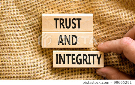 Trust and integrity symbol. Concept words Trust and integrity on wooden blocks. Businessman hand. Beautiful canvas background. Business, psychological and trust and integrity concept. Copy space. Trust and integrity symbol. Concept words Trust and integrity on wooden blocks. Businessman hand. Beautiful canvas background. Business, psychological and trust and integrity concept. Copy space. 99665291
