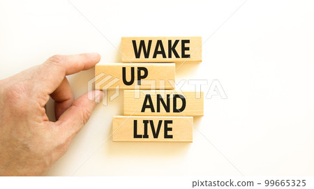 Wake up and live symbol. Concept words Wake up and live on wooden blocks. Beautiful white table white background. Businessman hand. Business lifestyle wake up and live concept. Copy space. 99665325