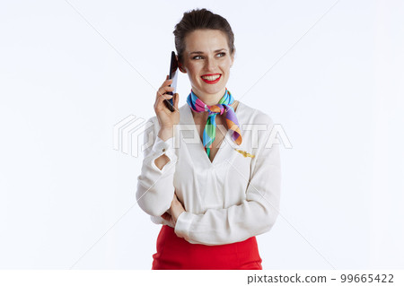 happy stylish air hostess woman on white using smartphone happy stylish air hostess woman on white using smartphone 99665422