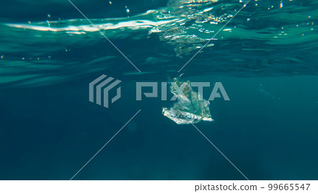 close-up of a plastic bag floating in the sea. Garbage in the sea water. Environmental Pollution of plastic rubbish pollution in oceans and seas. Environment, Pollution concept 99665547