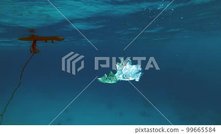 close-up of a plastic bag floating in the sea. Garbage in the sea water. Environmental Pollution of plastic rubbish pollution in oceans and seas. Environment, Pollution concept 99665584