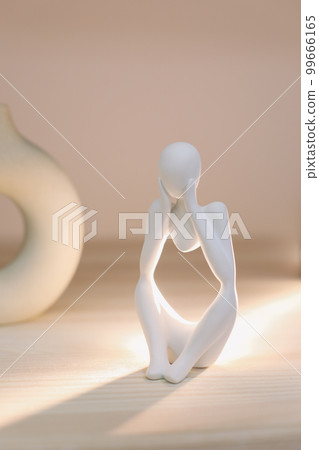 White gypsum decorative figure against beige background with copy space. Concept of template for website or commercial banner White gypsum decorative figure against beige background with copy space. Concept of template for website or commercial banner 99666165