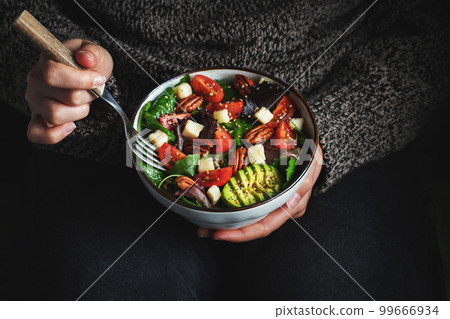 Healthy homemade salad with tomatoes, cheese cubes, pecans, avocado, spinach and arugula. Healthy homemade salad with tomatoes, cheese cubes, pecans, avocado, spinach and arugula. 99666934