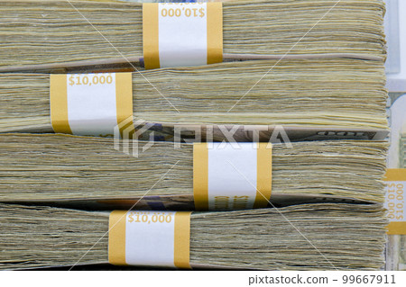 Close up of 4 straps of 100 dollar bills totaling ten thousand US dollars each stacked on top of each other, side view. High quality photo Close up of 4 straps of 100 dollar bills totaling ten thousand US dollars each stacked on top of each other, side view. High quality photo 99667911
