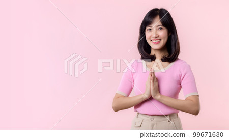 Portrait beautiful young asian woman happy smile with Sawasdee, hello gesture in Thai culture Siam traditional greeting style isolated on pink pastel background. 99671680